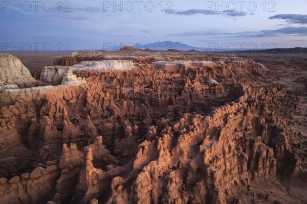 Aerial photograph capturing the breathtaking landscape of Goblin Valley State Park, Utah, showcasing its unique sandstone formations and captivating geological features under a vast sky