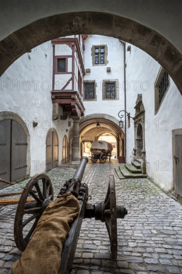 Cannon and horse-drawn carriage in the inner courtyard of the Gothic part of the town hall, Old town hall portal with lantern and passageway, Rothenburg ob der Tauber, Franconia, Bavaria, Germany