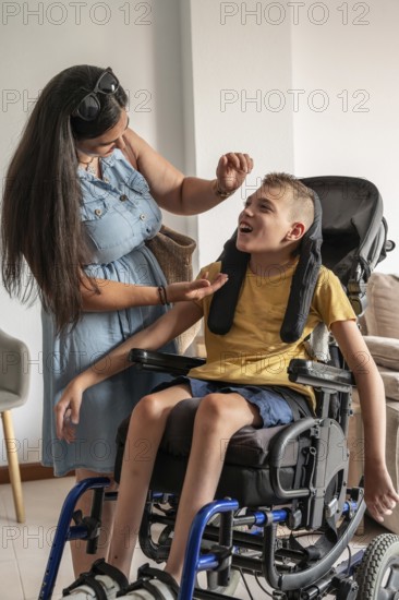 A mother lovingly cares for her son, who has cerebral palsy, sitting in a wheelchair. The scene captures their bond, highlighting warmth, support, and compassion