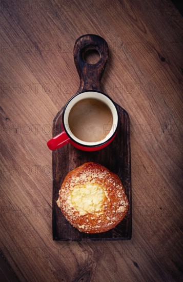 Pastries, breakfast, a bun with cottage cheese and a cup of coffee, top view, no people