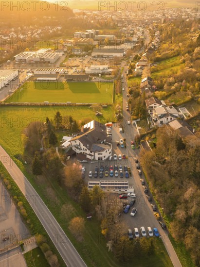 Aerial view of a road through a rural and urban environment at sunset, Europäischer Hof, Königsbach, Germany