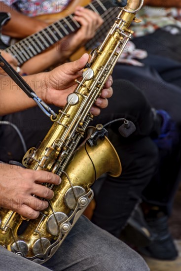 Saxophonist and other instrumentalists playing on the streets of the city of Recife, Recife, Pernambuco, Brazil