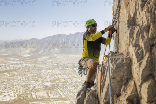 A man skillfully practices mountaineering and rappelling on the rugged cliffs of Eagleâ€™s Nest in Monterrey, Mexico, showcasing adventurous spirit and outdoor excitement