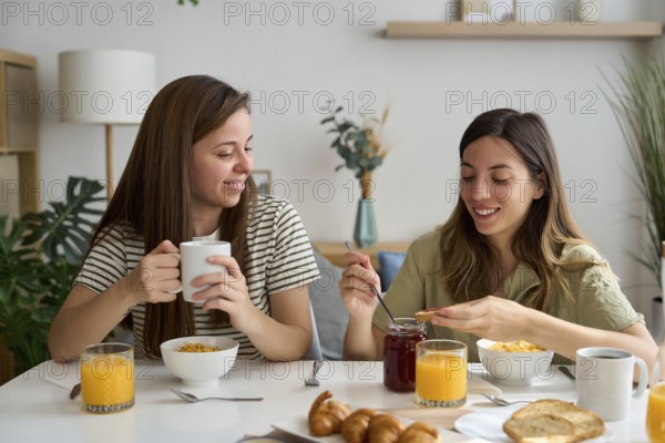 A loving lesbian couple shares a cozy breakfast at home, surrounded by morning light and comfort Their expression of affection reflects pride and equality in the LGBTQIA+ community
