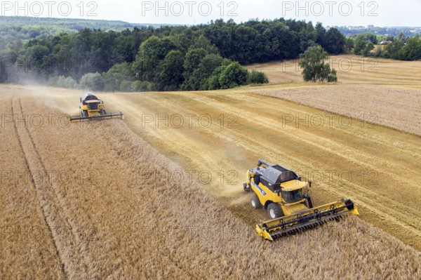Grimma, 18.07.13 Harvesters harvesting in a field near Grimma. The picture was taken with a remote-controlled drone, Grimma, Germany