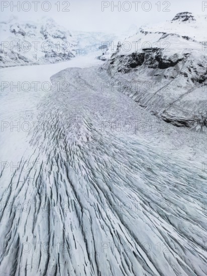Aerial view of the stunning Icelandic winter landscape, showcasing remote, wild nature with snow-covered mountains and ice formations, highlighting the pristine cold beauty, Ã–rÃ¦fi, Austurland, Islandia
