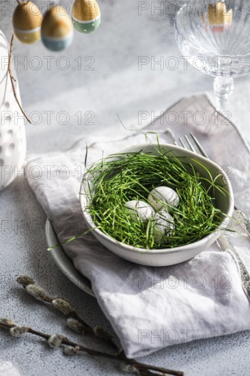 A fresh Easter setting featuring painted eggs tucked delicately within lush green grass, arranged in a ceramic bowl, complemented by subtle spring accents. This composition exudes the spirit of rebirth and renewal synonymous with the holiday