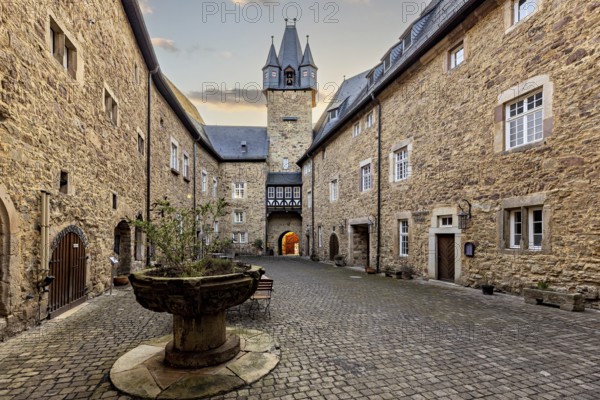 Inner courtyard with a view of a church tower and stone walls in the late afternoon light, The inner courtyard of Spangenberg Castle