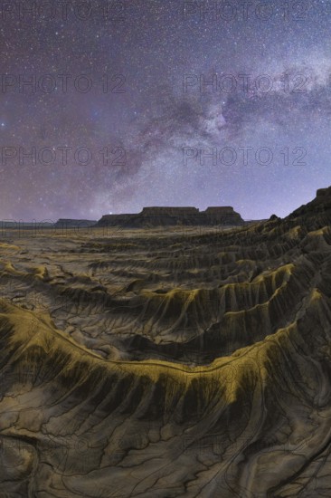 Stunning capture of the Milky Way illuminating the textured sandstone desert landscape in Utah, United States, showcasing the vast beauty of the natural world