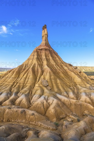 Majestic castildetierra rock formation rises against a vibrant blue sky in the bardenas reales desert, showcasing the power of erosion and the beauty of nature