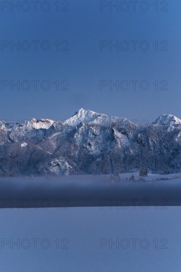 Shortly after sunset, twilight at Lake Hopfensee in the Allgäu in Bavaria in a winter landscape, Germany
