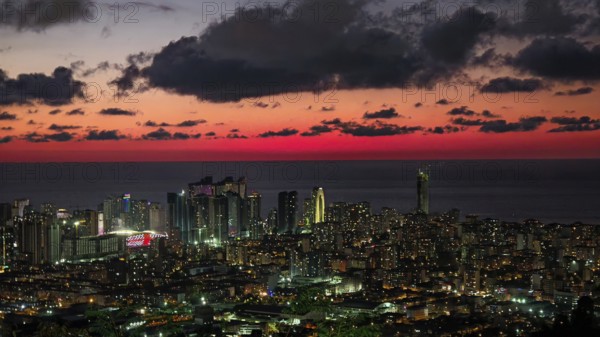 Illuminated skyline at impressive sunset with clouds in the sky, Batumi, Georgia