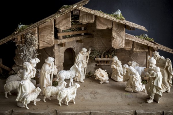 Christmas crib, Tyrolean crib figures with Christ Child, Saint Family, Shepherds, Sheep, Ox and Donkey and Three Kings in front of a crib building, Christmas story