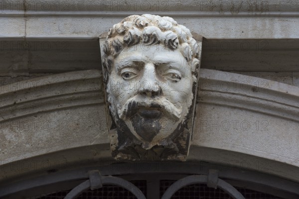 Sculpture of a head above a gate, Venice, Veneto, Italy