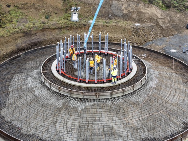 Concreting, concreting the foundation of a wind turbine, more than 600 cubic meters of concrete will be pumped into the foundation for over 7 hours, over 100 tons of reinforcing steel have been used, the wind turbine will have a hub height of 160 meters, part of a new wind farm in Sauerland, near Balve, North Rhine-Westphalia, Germany