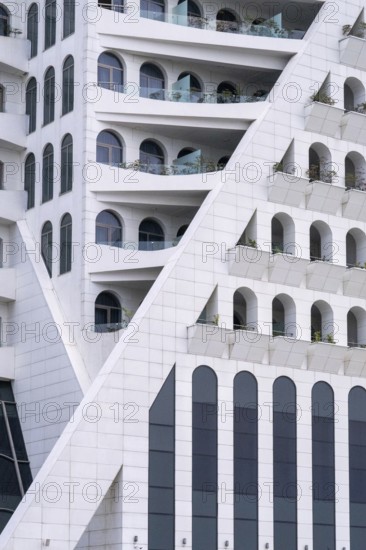 A striking modern building features geometric patterns and arches, located in Georgia. The white facade reflects contemporary architectural elegance and innovation