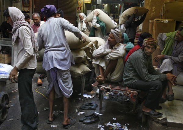 New Delhi, India, 14.01.10 - Workers stacking bags at market, India