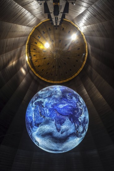 Oberhausen, North Rhine-Westphalia, Germany, Gasometer Oberhausen. The exhibition DAS ZERBRECHLICHE PARADIES focuses on the climate history of our planet. In the 100 metre high airspace of the gasometer, the 20 metre high sculpture of the globe shows animated high-resolution satellite images. The Gasometer Oberhausen is an industrial monument in Oberhausen and the highest exhibition and event hall in Europe