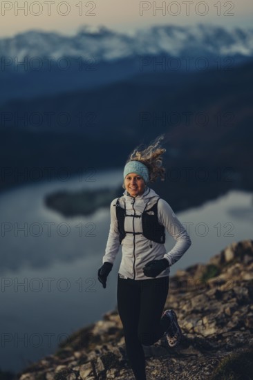 Trail running in autumn on the Jochberg on Lake Walchensee against the wonderful backdrop of the Alps, Bavaria, Germany