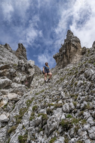 Mountaineer on the steep ascent to Waxenstein, Wetterstein Mountains, Garmisch-Patenkirchen, Bavaria, Germany