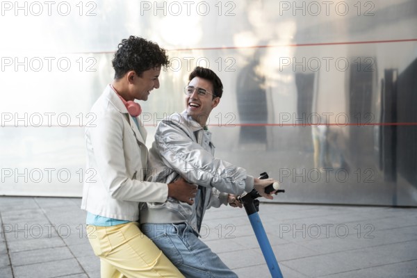 A cheerful gay couple enjoying a scooter ride together on a sunny day, wearing casual outfits. Their happiness and connection are evident as they share this fun experience