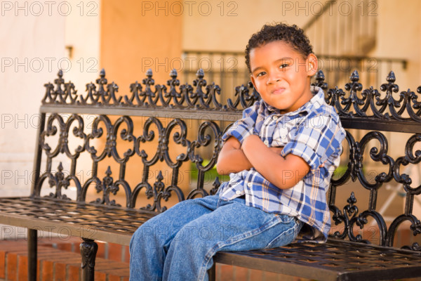 Handsome African American and Mexican Boy Sitting on Park Bench