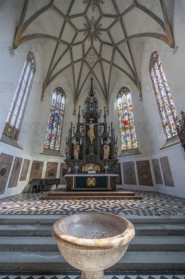 High altar in the late Gothic church of St Martin, baptismal font in front, first construction around 800, Memmingen, Bavaria, Germany