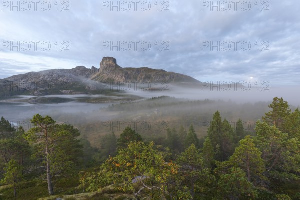 Magical morning fog on Steigtindvatnet in front of the majestic Steigtinden in Norway near Bodø
