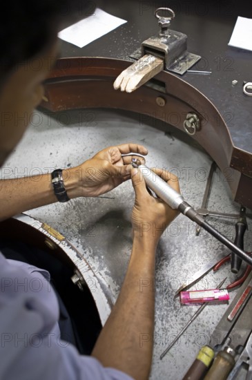 Gemstone cutter cutting a sapphire ring, gemstone cutting workshop in Kandy, Central Province, Sri Lanka