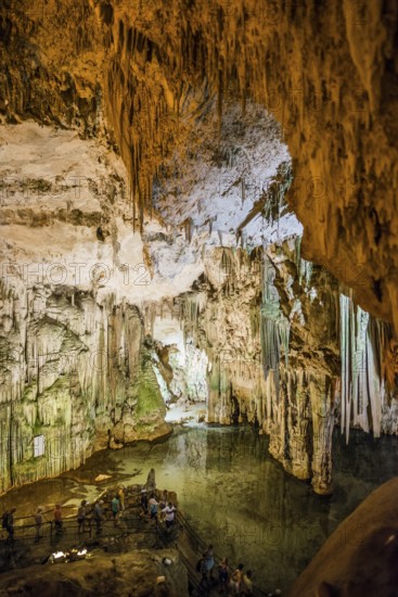 Huge stalactites and underground lake, stalactite cave, Grotta di Nettuno, Neptune Grotto, Capo Caccia, near Alghero, Sardinia, Italy