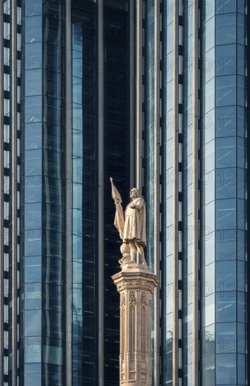 A striking display of architectural contrast in Colon City, Panama, showing a historic statue against the backdrop of sleek, modern glass skyscrapers