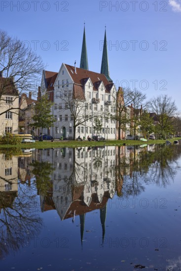 Historic house, towers of Lübeck Cathedral, trees, reflections on the surface of the water, Hanseatic City of Lübeck, independent city, Schleswig-Holstein, Germany