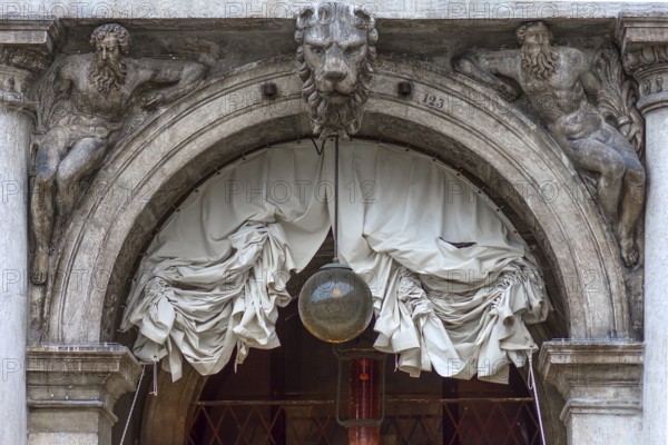 Sculptures on the round arch of the arcades in St. Mark's Square, Venice, Veneto, Italy