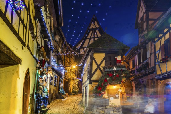 Houses illuminated and decorated for Christmas, Christmas market, blue hour, Eguisheim, Haut-Rhin department, Grand Est region, Alsace, France