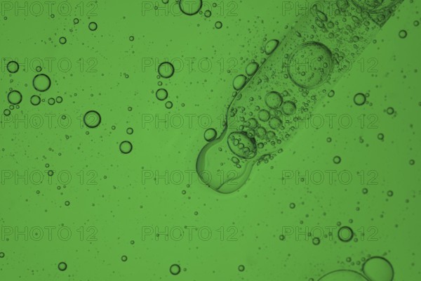 A detailed image showcasing a vibrant aloe vera liquid for a serum cosmetic, creating a mesmerizing texture and pattern