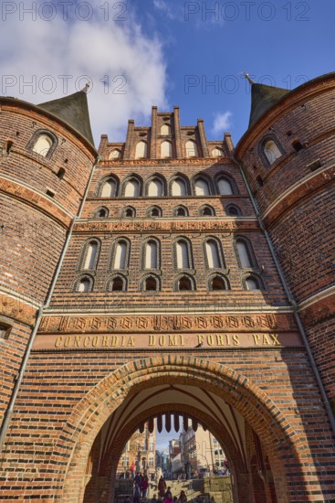 City gate Lübeck Holstentor, inscription Concordia domi foris pax with the meaning harmony inside peace outside, frog perspective, Hanseatic city of Lübeck, independent city, Schleswig-Holstein, Germany