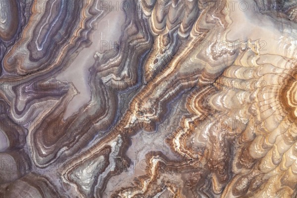 Aerial capture of bentonite sandstone formations in Utah, USA, showcasing intricate patterns and rich textures in earthy hues, revealing nature's artistry