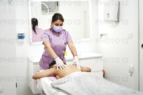 Skilled therapist provides a relaxing massage to a client at a professional beauty salon. The tranquil environment enhances the overall experience, promoting wellness and rejuvenation