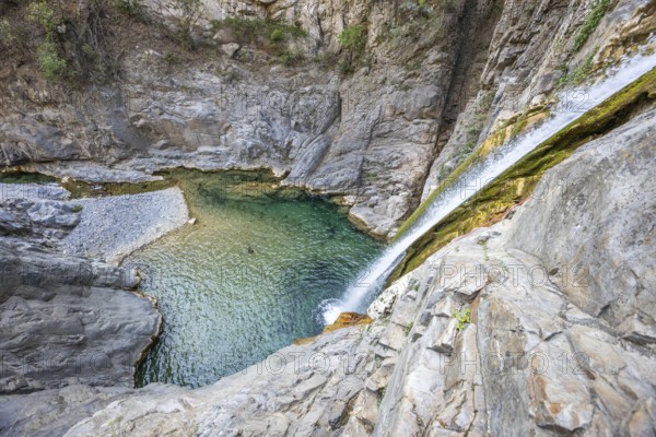 A breathtaking view of a canyon with crystal-clear waters, perfect for adventure seekers enjoying canyoning, rappelling, or hiking in Nuevo Leon, Mexico's rugged terrain