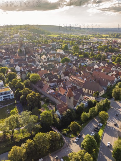 View of a historic old town with dense roofs, towers and surrounded by green trees and streets, Weil der Stadt, Germany