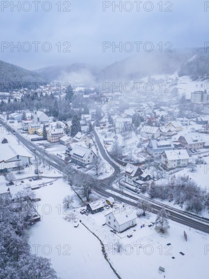 Small snow-covered village in a wooded mountain landscape, shrouded in mist, Enzklösterle, Calw district, Black Forest, Germany