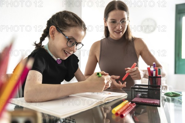 A joyful family moment as a girl with a tracheostomy engages in coloring activities with her sister