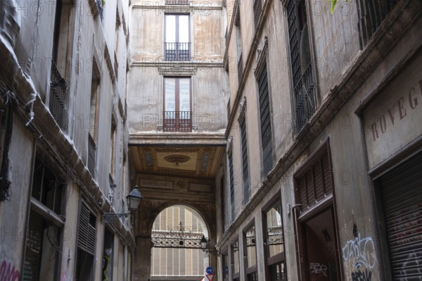 Alley and building bridge in the historic centre of Barcelona, Spain