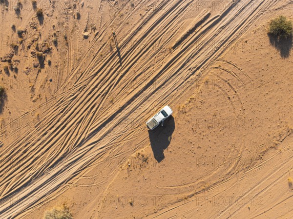 Aerial view, lonely road with offroad car, desert landscape, Erongo, Damaraland, Namibia