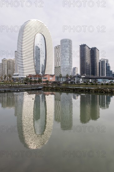 Stunning view of modern highrise architecture in Batumi, Georgia, with sleek buildings reflecting in the calm waters of a scenic cityscape. A beautiful blend of urban design