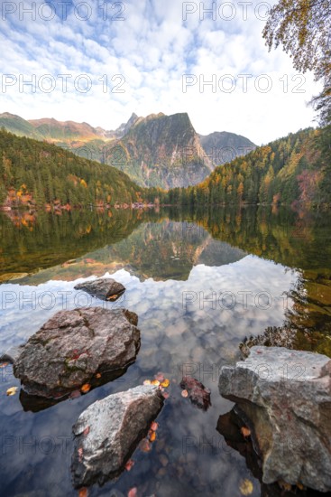 Mountain peaks of the Ötztal Alps reflected in Lake Piburger See, in autumn, near Ötz in Ötztal, Tyrol, Austria