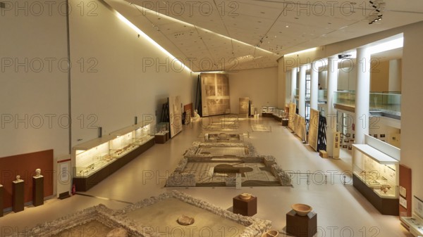 Long room in the museum with archaeological artifacts and well-lit display cases, Patras Archaeological Museum, Patras, Peloponnese, Greece