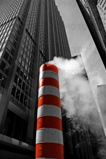 Steaming chimney at a construction site behind a skyscraper, New York City, USA