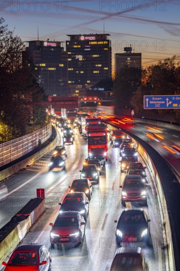 Evening traffic, partly with traffic jams, slow-moving traffic on the A40 motorway, Essen skyline, Evonik Group headquarters, Essen, North Rhine-Westphalia, Germany