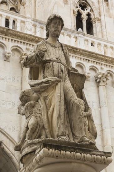 Close-up of statue of Saint Lawrence in front of old Gothic Church of Saint Sebastian, St. Lawrence Square, Trogir, Croatia